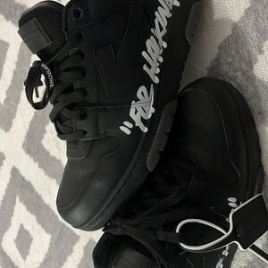 Black tennis shoes off whites